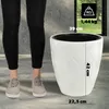 A person's legs and feet are shown next to a white planter with dimensions and weight indicated. Náhľad obrázku produktu