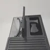 A close-up, angled view of the top of a black coffee machine. Produktbild-Vorschau