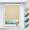 A window with beige pleated blinds and a small vase with flowers on the windowsill. Produktbild-Vorschau