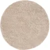 A round, beige rug is shown from a top-down perspective on a white background. Anteprima dell’immagine prodotto