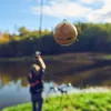 A person fishing by a lake with a Deeper Sonar Chirp+ 2 hanging from a fishing line. Voir les images du produit
