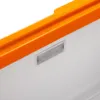 A close-up view of the top edge of a white cooler with an orange trim and a small rectangular clear plastic component embedded in the white surface. Produktbild-Vorschau