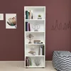 A white bookshelf filled with books and decorative items against a dark red wall. Produktbild-Vorschau