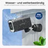 A security camera mounted on a wall, being sprayed with water, indicating its weather resistance. Produktbild-Vorschau