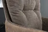 A close-up view of the textured fabric and tufted details of a chair. Produktbild-Vorschau