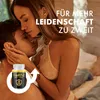 A couple embracing intimately, with a product bottle and a male symbol overlayed. Produktbild-Vorschau