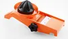 An orange and black vegetable slicer with a citrus juicer attachment is shown on a white background. Voir les images du produit