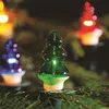 Close-up of Christmas tree lights shaped like trees, with other lights blurred in the background. Podgląd zdjęcia produktu