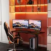 A modern home office setup with an adjustable desk, dual monitors, and a gaming chair. Voir les images du produit