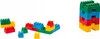 Several colorful building blocks are arranged in two separate groups on a white background. One group forms a small boat-like structure, while the other is a tall stack of blocks. Náhľad obrázku produktu