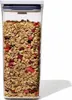 A clear, well-lit studio shot of a clear plastic food storage container filled with granola. Náhled obrázku produktu