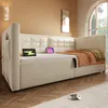 A bedroom scene with a beige sofa bed, tablets, and a window. Produktbild-Vorschau