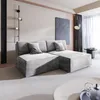A modern living room with a gray sectional sofa, artwork on the wall, and curtains.