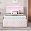 A bed with a tufted headboard and footboard, illuminated by pink LED lights. Produktbild-Vorschau