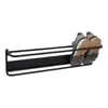 A black metal shoe rack mounted on a white background, with a pair of gray and black sneakers placed on it. Produktbild-Vorschau