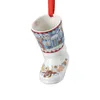 A ceramic Christmas ornament shaped like a boot, hanging from a red ribbon. Produktbild-Vorschau
