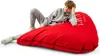 A young person is lounging on a large red beanbag chair. Náhled obrázku produktu