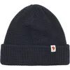 A dark navy knitted beanie with a small white logo patch on the front. Náhled obrázku produktu