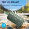 A green portable speaker is shown in a river with water splashing around it, suggesting it is waterproof and suitable for outdoor use. Náhľad obrázku produktu