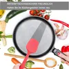 A cooking scene with a pan, spatula, and various vegetables, along with text overlay. Produktbild-Vorschau