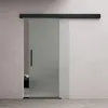 A frosted glass sliding door with a black handle, mounted on a black track against a textured wall. Produktbild-Vorschau
