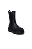 A studio shot of a single black boot. Voir les images du produit