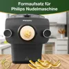 A Philips pasta maker attachment is shown on a wooden surface, with freshly made pasta in the foreground. The background is a blurred kitchen setting. Produktbild-Vorschau