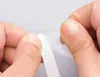 Hands are shown peeling a white strip off a clear plastic tape. Náhľad obrázku produktu
