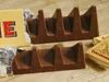Two Toblerone chocolate bars are shown on a wooden surface, with packaging visible. Anteprima dell’immagine prodotto