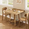 A wooden table and chairs set in a bright room with windows. Podgląd zdjęcia produktu