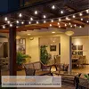An outdoor patio area at night, decorated with string lights. Náhled obrázku produktu