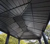 Underside view of a dark gray metal gazebo roof with green trees and blue sky visible in the background. Náhľad obrázku produktu