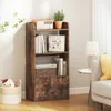 A wooden bookshelf with items on it, placed in a room next to a sofa. Podgląd zdjęcia produktu