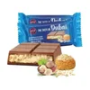 A chocolate bar and its packaging are displayed with decorative elements. Náhľad obrázku produktu
