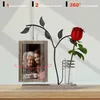 A decorative wooden photo frame with a metal tree branch holding a red rose in a glass vase, displaying two photos of women. Produktbild-Vorschau