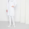 A person wearing a white lab coat and white pants, standing against a white background. Produktbild-Vorschau