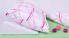 A wedge pillow with a pink patterned pillowcase rests on a light green surface, with three decorative balls nearby. Náhled obrázku produktu