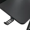 A close-up view of the textured surface of a black gaming desk with a headphone hook attached underneath. Voir les images du produit