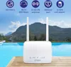 A white router with two antennas is placed on a wooden deck in front of a swimming pool and mountains. Anteprima dell’immagine prodotto