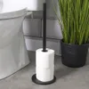 A black toilet paper holder with two rolls of toilet paper is shown next to a toilet and a potted plant. Voir les images du produit