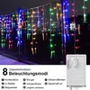 A string of colorful LED icicle lights hanging outdoors at night, with a control box visible in the lower right corner. Náhled obrázku produktu