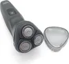 A black electric shaver with three rotating heads is shown on a white background, with its protective cap placed to the side. Podgląd zdjęcia produktu