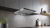 A modern kitchen with a stainless steel range hood installed above a countertop. Voir les images du produit