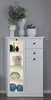 A white display cabinet with glass doors and drawers, filled with decorative items and plants. Produktbild-Vorschau