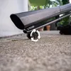 Close-up of a black leaf blower's wheel on a concrete surface. Produktbild-Vorschau
