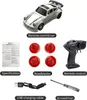 A collection of items related to a remote control car, including the car itself, a remote control, charging cable, screwdriver, and road blocks. Náhled obrázku produktu
