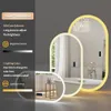 A bathroom mirror with integrated LED lighting, shown in a stylized setting with a bathtub. Podgląd zdjęcia produktu