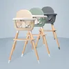 Three baby high chairs in different colors displayed side-by-side against a light blue background. Anteprima dell’immagine prodotto