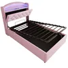 A pink upholstered bed frame with the mattress support raised, revealing storage space underneath. The headboard has integrated LED lighting. Náhled obrázku produktu
