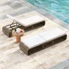 Two lounge chairs by a pool on a rug. Náhled obrázku produktu